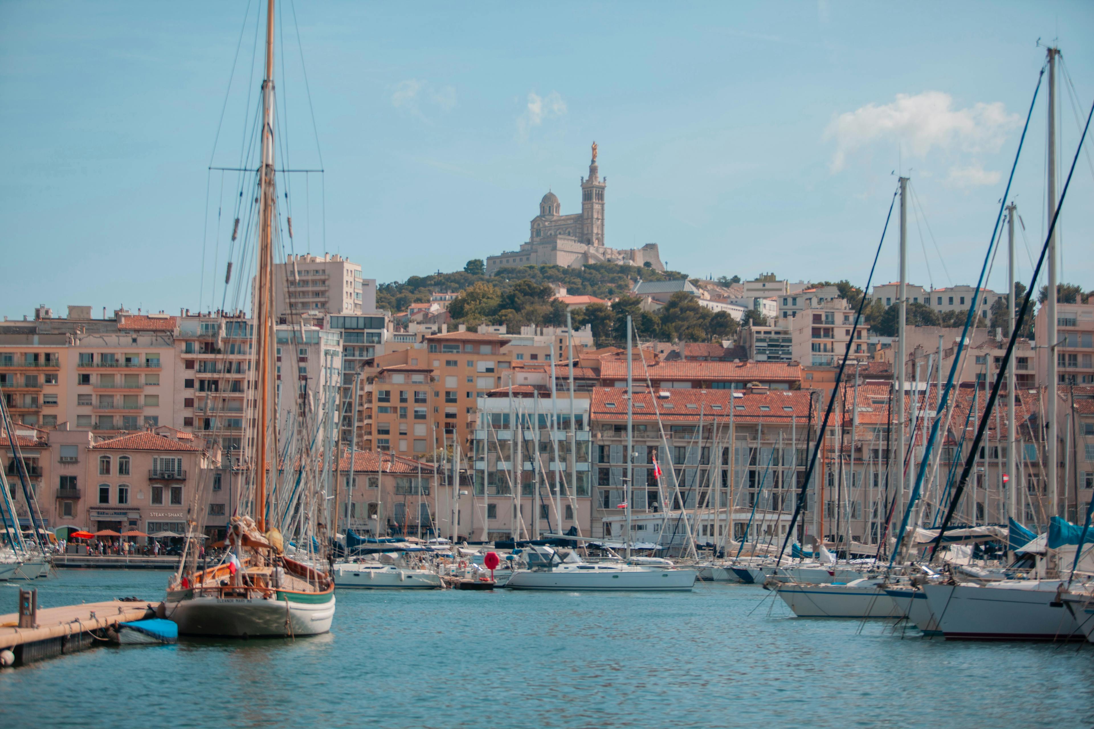Vue du Vieux-Port de Marseille et de ses voiliers avec Notre-Dame-de-la-Garde en arrière plan